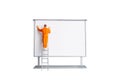 Miniature people Painter at The front of a whiteboard isolated on white background Royalty Free Stock Photo