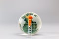 Painters are polishing a crystal globe, and the concept of World Earth Day