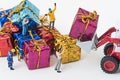 Miniature people prepare to transport gift box