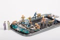 The miniature people repair smartphone