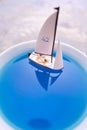 Miniature people, Rowing boat in the ocean in cup.  Image use for life style concept Royalty Free Stock Photo