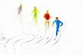 Miniature people running on center of maze and thinking how to solve this problem. Concepts of finding a solution, problem Royalty Free Stock Photo