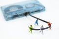 Miniature people running to tape cassette for winner . Image use for healthy , exercise concept Royalty Free Stock Photo