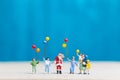 Miniature people: Santa Claus and children holding balloon Royalty Free Stock Photo