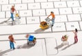 Miniature people with shopping carts on a keyboard Royalty Free Stock Photo