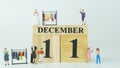 Miniature people Shopping at Women`s clothing store.Wooden letters write the word December and the numbers 11 on white background Royalty Free Stock Photo