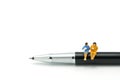 Miniature people Sit on the pens, exchange ideas, discuss problems using as background business concept and finance concept with c Royalty Free Stock Photo