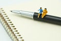 Miniature people Sit on the pens, exchange ideas, discuss problems using as background business concept and finance concept with c Royalty Free Stock Photo