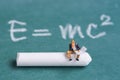 miniature people sitting on chalk stick with the relativity theory background