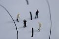 Miniature people: Small businessman figures walking on the street.