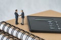 Miniature people: Small figure businessmen handshaking and stand Royalty Free Stock Photo