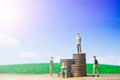 Miniature people small figures businessman stand on money of coin stack step up growing growth on blue sky and white cloud Royalty Free Stock Photo