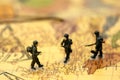 Miniature people : soldiers team with world map,War, army, military, guard concept. Royalty Free Stock Photo