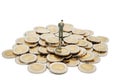 Miniature people standing on pile of new 10 Thai Baht coins. Royalty Free Stock Photo