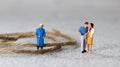 Miniature people standing with rope. Royalty Free Stock Photo