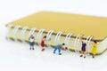 Miniature people: Student reading book with big book, library. Image use for education concept Royalty Free Stock Photo