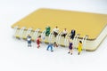 Miniature people: Student reading book with big book, library. Image use for education concept Royalty Free Stock Photo