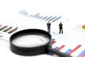 Miniature people : Successful businessman with magnifying glass of young businessman with Paper graph chart ,Business Growth