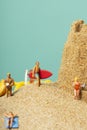 Miniature people in swimsuit on the beach Royalty Free Stock Photo