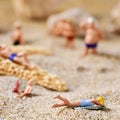 Miniature people in swimsuit on the beach