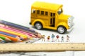 Miniature people : teacher and student with colorful drawing tools and stationary of school bus,education concept Royalty Free Stock Photo