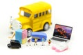 Miniature people : teacher and student with colorful drawing tools and stationary of school bus,education concept Royalty Free Stock Photo