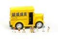 Miniature people : teacher and student with colorful drawing tools and stationary of school bus,education concept Royalty Free Stock Photo