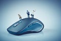 Miniature people on top of computer mouse. Business concept Royalty Free Stock Photo