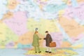 Miniature people : Tourist handshake on world map background Royalty Free Stock Photo