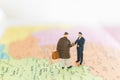 Miniature people : Tourist handshake on world map background Royalty Free Stock Photo