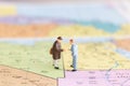 Miniature people : Tourist handshake on world map background Royalty Free Stock Photo