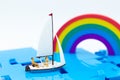 Miniature people : Tourist ride ship along the rainbow. Image use for travel concept