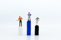 Miniature people : Tourist walking on colorful block podium. Image use for travel concept