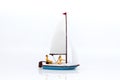 Miniature people: Tourists with sports sailing. Image use for travel business concept