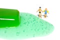 Miniature people toy figure photography. Creative summer vacation concept. Brother and sister looking on green watermelon melting