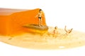 Miniature people toy figure photography. Creative summer vacation concept. A Kid standing above melting ice cream stick ready to