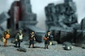 Miniature people toy figure photography. A group of refugee walking, moving in the middle of ruined demolish city, because of war