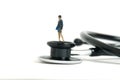 Medical checkup schedule concept. A businesswoman standing above stethoscope. Isolated on Royalty Free Stock Photo