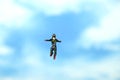 Miniature people toy figure photography. A men doing sky diving jump in cloudy bright day Royalty Free Stock Photo