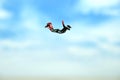 Miniature people toy figure photography. A men doing sky diving jump in cloudy bright day Royalty Free Stock Photo