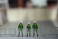 Miniature people toy figure photography. A military anti riot armored army standing on barricades, securing the road way