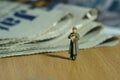 Miniature people toy figure photography. A military mail officer holding news pack envelope standing in front of newspaper