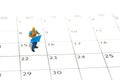 Miniature people toy figure photography. Project schedule time management concept. A construction worker holding blueprint Royalty Free Stock Photo