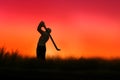 Miniature people toy figure photography. Silhouette of men golfer swing his stick at meadow field hill when sunset sunrise