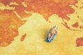 Miniature people toy figure photography. Travel destination concept, Men relaxing at beach chair on a map paper Royalty Free Stock Photo