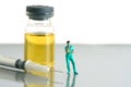 Miniature people toy figure photography. Urine test concept. A nurse standing in front of ampoule bottle and syringe Royalty Free Stock Photo