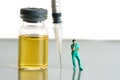Miniature people toy figure photography. Urine test concept. A nurse standing in front of ampoule bottle and syringe Royalty Free Stock Photo