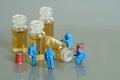 Miniature people toy figure photography. Vaccine clinical trial test. A group of paramedics with hazmat suit testing vaccine