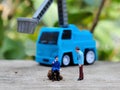 Miniature People and toys: Worker at the construction with chery picker truck background Royalty Free Stock Photo