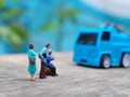 Miniature People and toys: Worker at the construction with chery picker truck background Royalty Free Stock Photo